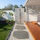 Greenbank landscaping services 1, Large stone pathway leading to outdoor shower with tropical gardens in Brisbanes Southside.